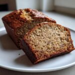 A close-up of a moist slice cut from a loaf of Protein banana bread, showing its texture.