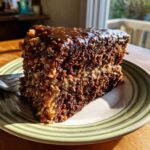 A moist slice of german chocolate cake recipe with coconut-pecan filling and chocolate glaze.