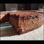 Close-up of a thick, airy slice of homemade chocolate mousse dusted with cocoa powder.