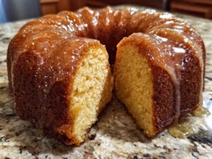 Close-up of a freshly baked Bacardi Rum Cake, glazed and cut to show the moist interior crumb.