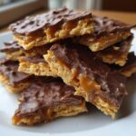 A close-up stack of rich Caramel Ritz Cracker Christmas Cookies bars with gooey caramel showing.
