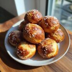 A stack of golden brown, freshly baked pretzel bites topped with coarse salt, ready for game day.