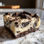 A single, rich square of white and dark chocolate Oreo fudge topped with cookie crumbs.