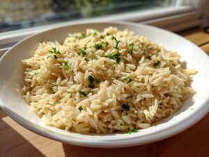 A close-up of fluffy rice pilaf, garnished with fresh parsley, served in a white bowl.