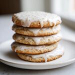 A stack of four delicious earl grey cookies topped with a thick, white glaze speckled with tea leaves.