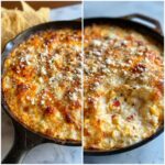 Close-up of a bubbling, cheesy elote dip served hot in a cast iron skillet with tortilla chips visible nearby.