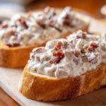 Close-up of creamy chipped beef on toast, showing chunks of beef in a white sauce on toasted bread.